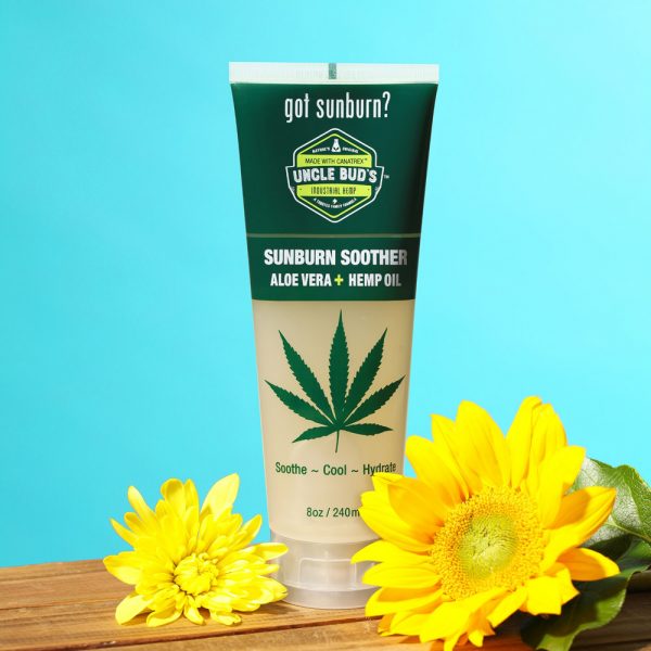 Uncle Bud's Hemp Sunburn Soother with flowers surrounding it.