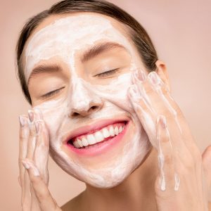 Woman applying facemask