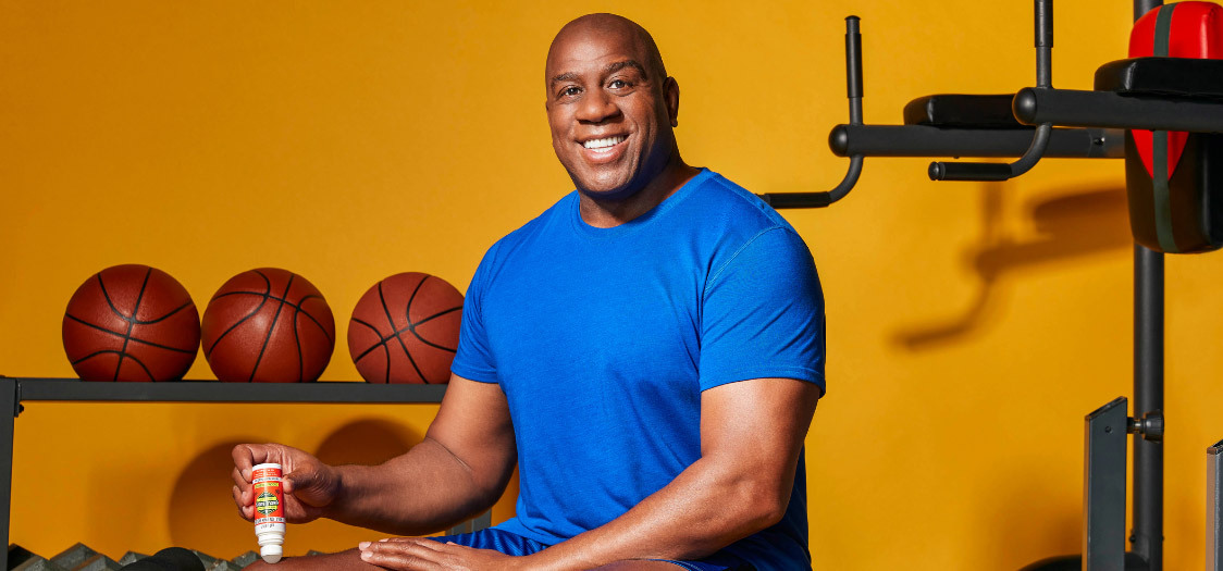 Magic Johnson using a CBD roll-on