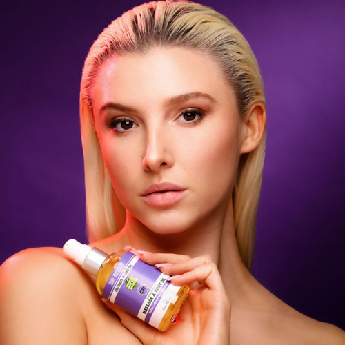 Woman Holding CBD Massage Oil